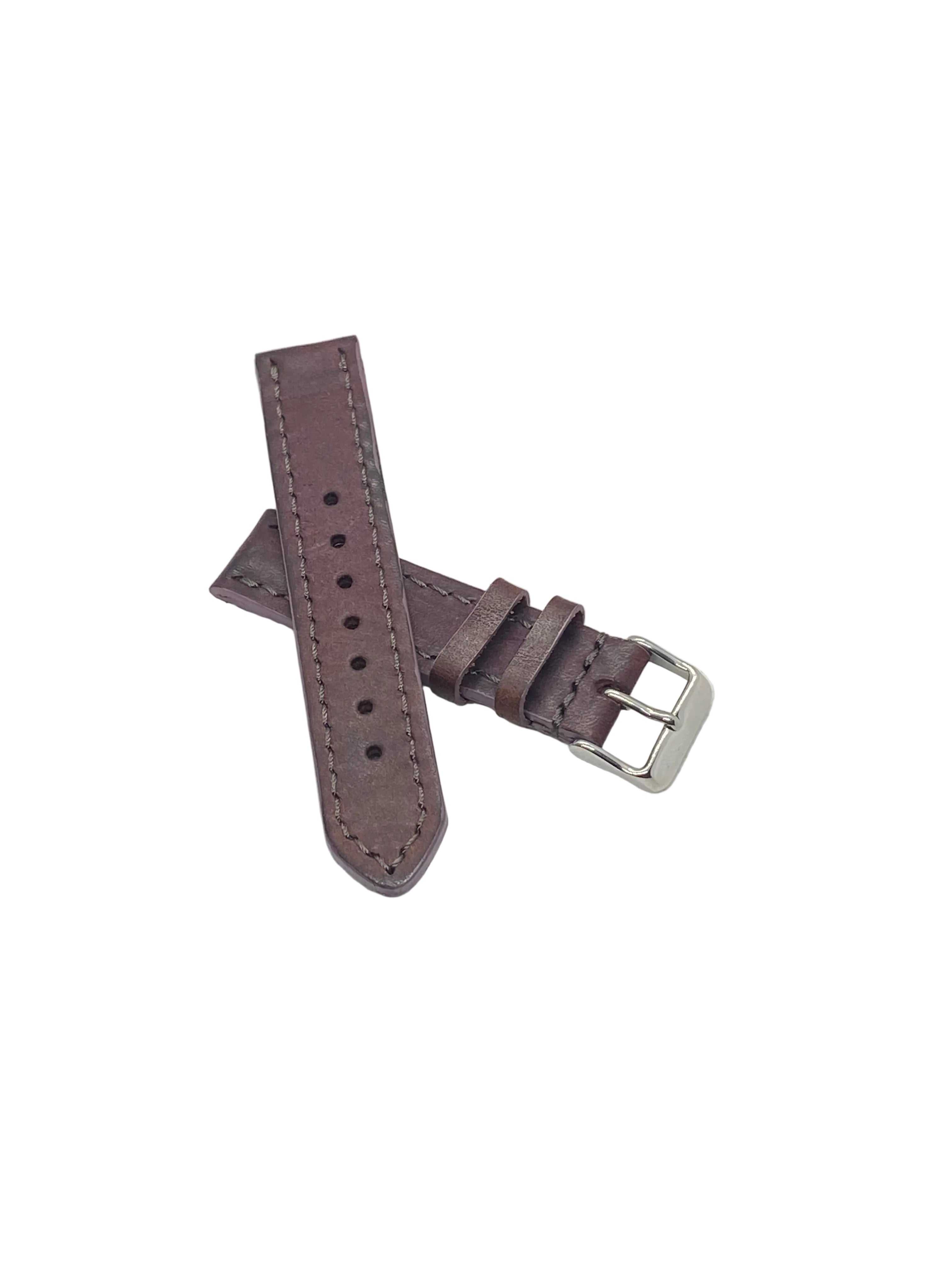 A purple plum badalassi carlo italian leather watch strap with a silver-toned metal buckle, laid flat on a textured white surface.