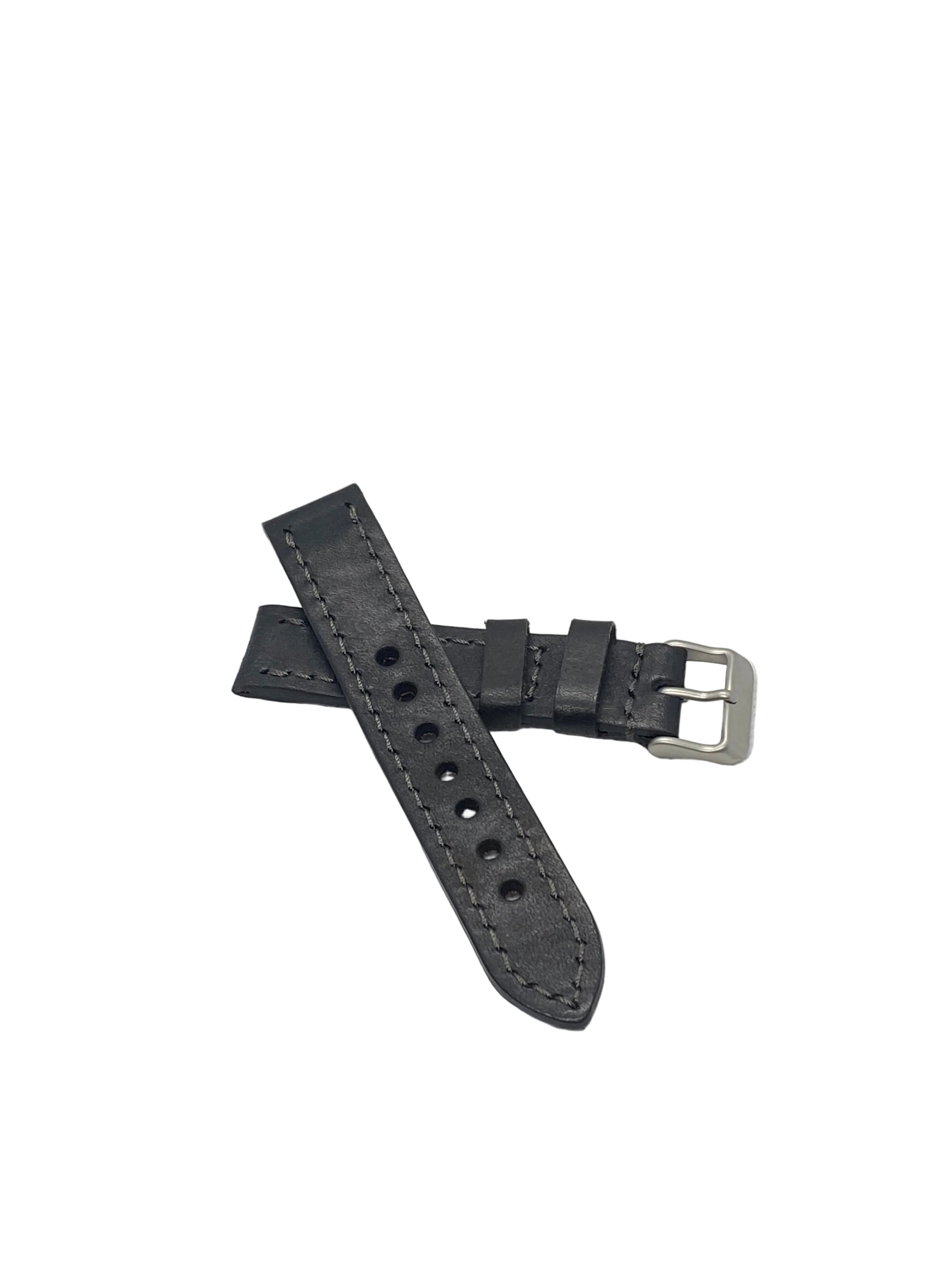 A black badalassi carlo italian leather watch strap with silver-toned hardware, laid on a textured white surface.